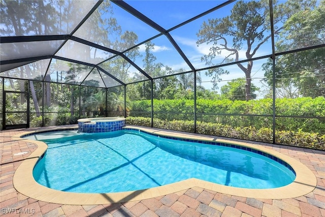 view of pool with a patio, a lanai, and a pool with connected hot tub