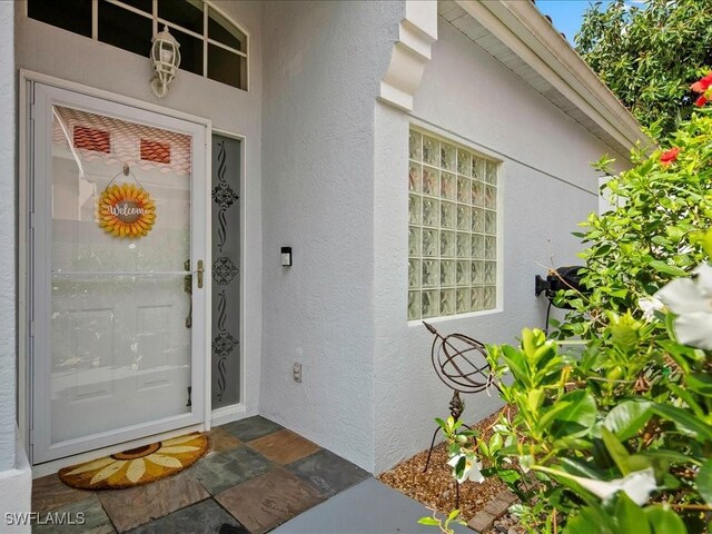 363 Pindo Palm Dr, Naples, FL 34104 - property entrance featuring stucco siding