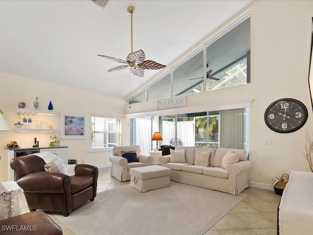 363 Pindo Palm Dr, Naples, FL 34104 - living room with light tile patterned floors, a ceiling fan, high vaulted ceiling, baseboards, and bar area