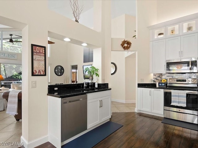 363 Pindo Palm Dr, Naples, FL 34104 - kitchen featuring appliances with stainless steel finishes, a high ceiling, a sink, white cabinets, and a ceiling fan