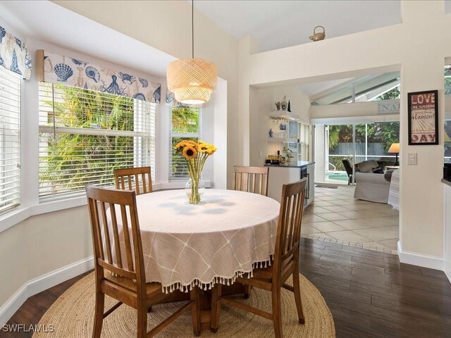 363 Pindo Palm Dr, Naples, FL 34104 - dining room featuring vaulted ceiling, baseboards, and wood finished floors