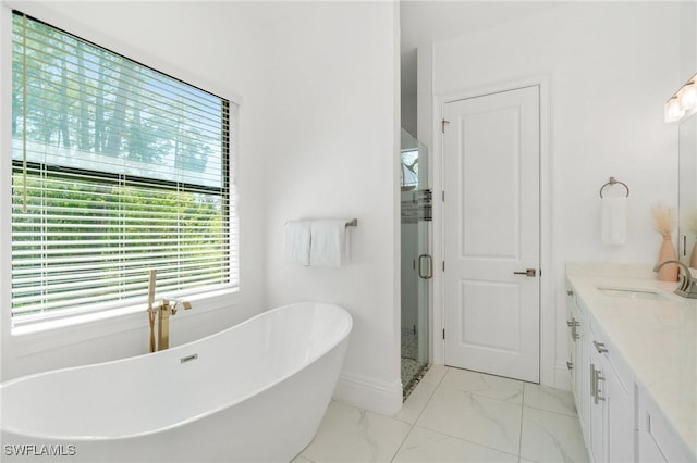 10191 Strike Ln, Bonita Springs, FL 34135 - full bath with vanity, marble finish floor, baseboards, a soaking tub, and a stall shower