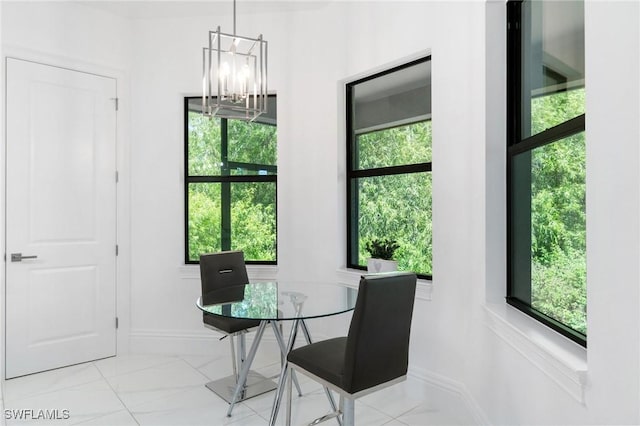 10191 Strike Ln, Bonita Springs, FL 34135 - dining room featuring baseboards, marble finish floor, and a notable chandelier