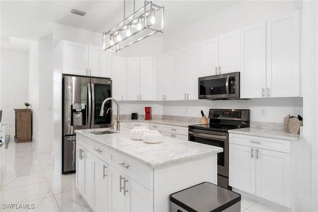 10191 Strike Ln, Bonita Springs, FL 34135 - kitchen with appliances with stainless steel finishes, a sink, an island with sink, marble finish floor, and visible vents