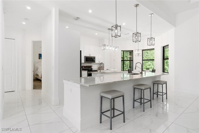 10191 Strike Ln, Bonita Springs, FL 34135 - kitchen featuring a sink, appliances with stainless steel finishes, a large island with sink, and visible vents