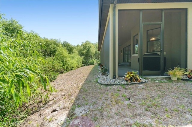 10191 Strike Ln, Bonita Springs, FL 34135 - view of side of home with a sunroom