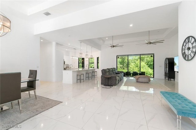 10191 Strike Ln, Bonita Springs, FL 34135 - living area with marble finish floor, recessed lighting, a ceiling fan, a tray ceiling, and visible vents