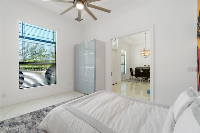 10191 Strike Ln, Bonita Springs, FL 34135 - bedroom with baseboards, a notable chandelier, and marble finish floor