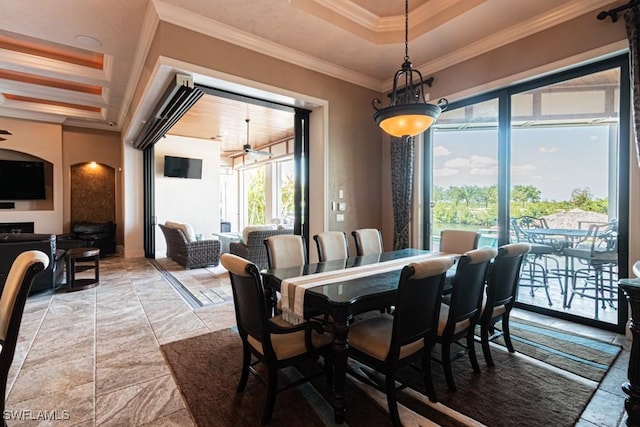 dining room featuring crown molding, ceiling fan, and a tray ceiling