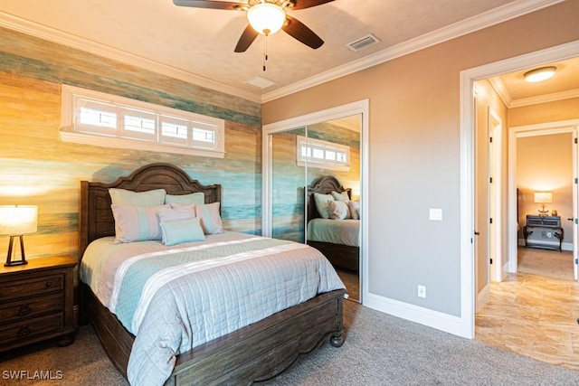 bedroom with a ceiling fan, visible vents, baseboards, a closet, and ornamental molding
