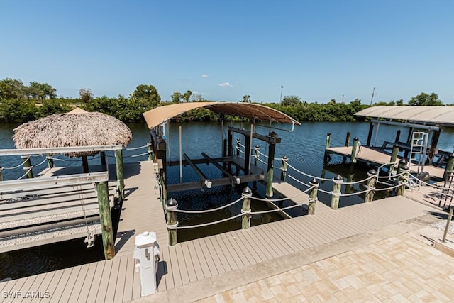 dock area with boat lift and a water view