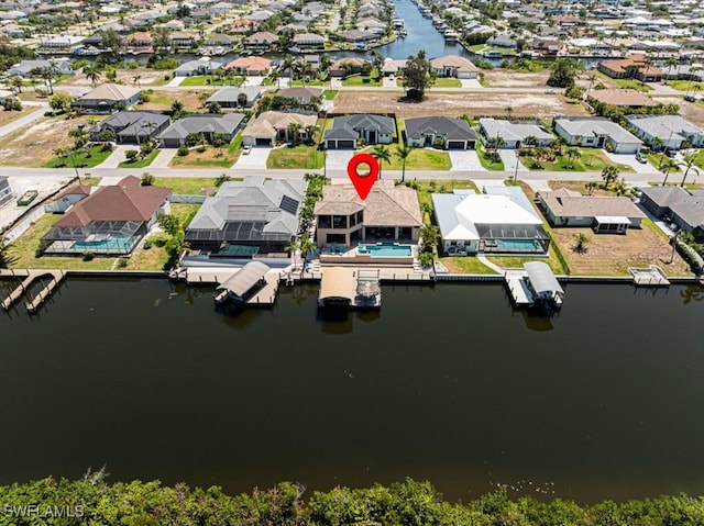 drone / aerial view with a water view and a residential view