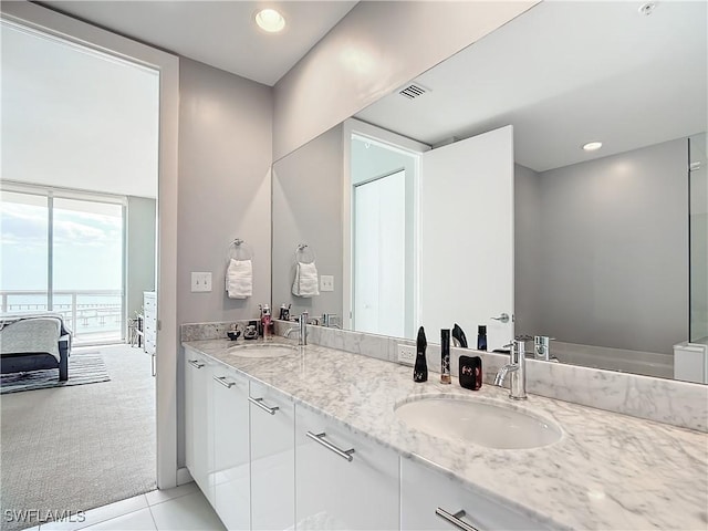 3000 Oasis Grand Blvd, Fort Myers, FL 33916 - ensuite bathroom featuring double vanity, a sink, tile patterned floors, and visible vents