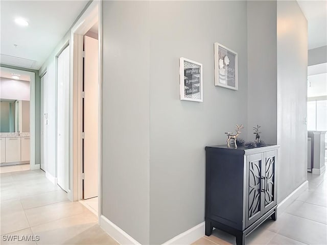3000 Oasis Grand Blvd, Fort Myers, FL 33916 - hallway with light tile patterned floors and baseboards