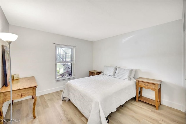 bedroom featuring light wood-style flooring and baseboards