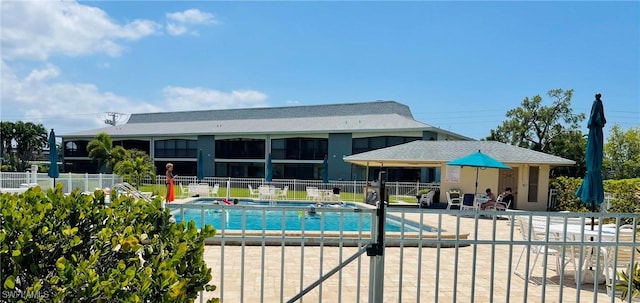 community pool featuring fence and a patio