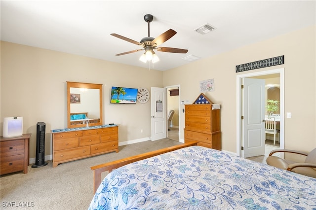 bedroom featuring visible vents, a ceiling fan, baseboards, and carpet floors