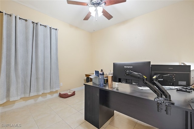 home office with a ceiling fan, baseboards, and tile patterned flooring