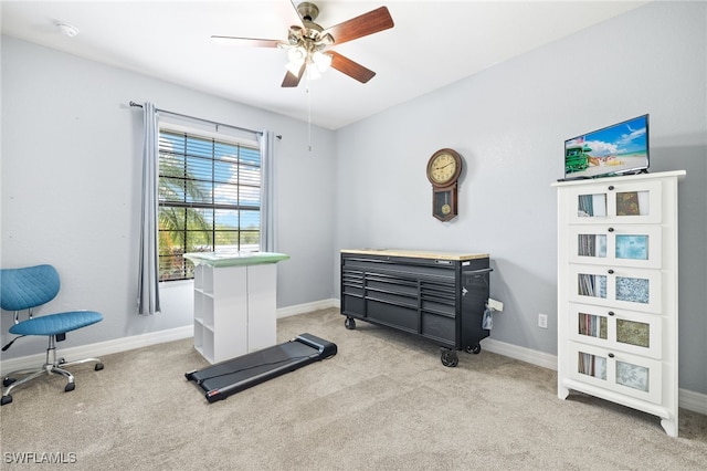 workout area featuring baseboards, carpet, and ceiling fan