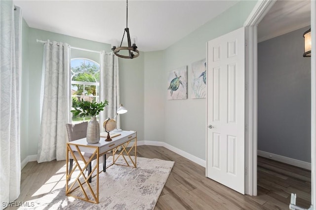 2733 Island Pond Ln, Naples, FL 34119 - home office featuring a chandelier, baseboards, and wood finished floors