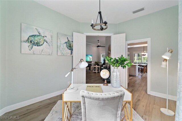2733 Island Pond Ln, Naples, FL 34119 - dining area featuring a chandelier, light wood-type flooring, and baseboards