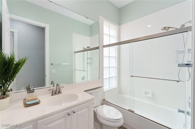2733 Island Pond Ln, Naples, FL 34119 - bathroom featuring toilet, vanity, and combined bath / shower with glass door