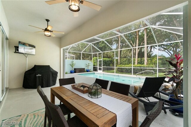 2733 Island Pond Ln, Naples, FL 34119 - view of patio / terrace with ceiling fan, an outdoor pool, outdoor dining area, and glass enclosure