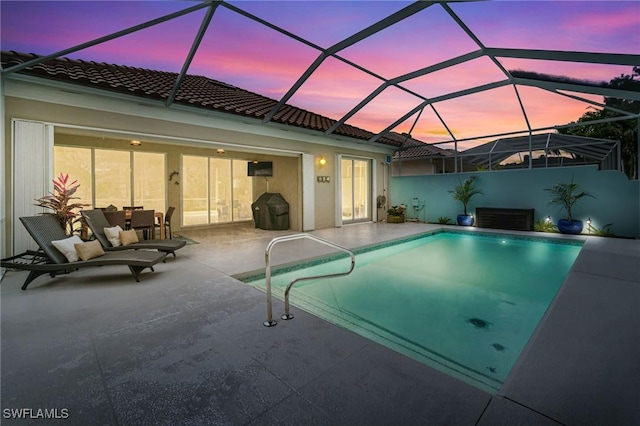 2733 Island Pond Ln, Naples, FL 34119 - pool at dusk with a patio area, an outdoor pool, and a lanai