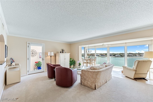 carpeted living room featuring ornamental molding, a textured ceiling, and a water view