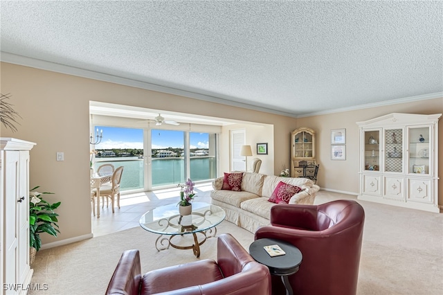 living room with light carpet, a textured ceiling, ornamental molding, baseboards, and a water view