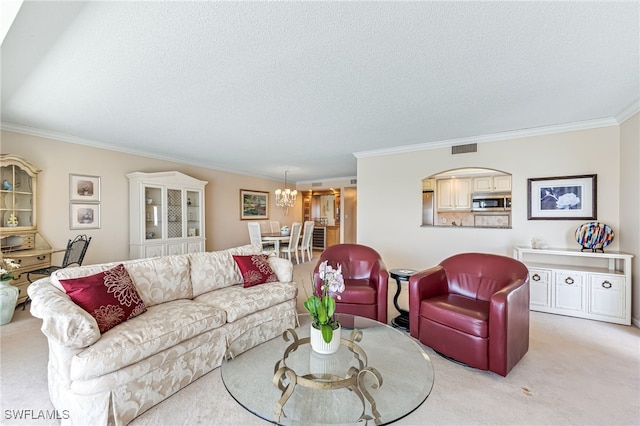 living room with ornamental molding, a chandelier, light colored carpet, and a textured ceiling