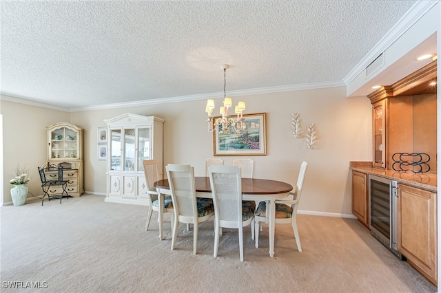 dining room featuring beverage cooler, a textured ceiling, a chandelier, light carpet, and ornamental molding