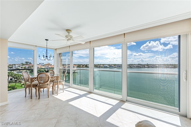 sunroom / solarium featuring a water view and a chandelier