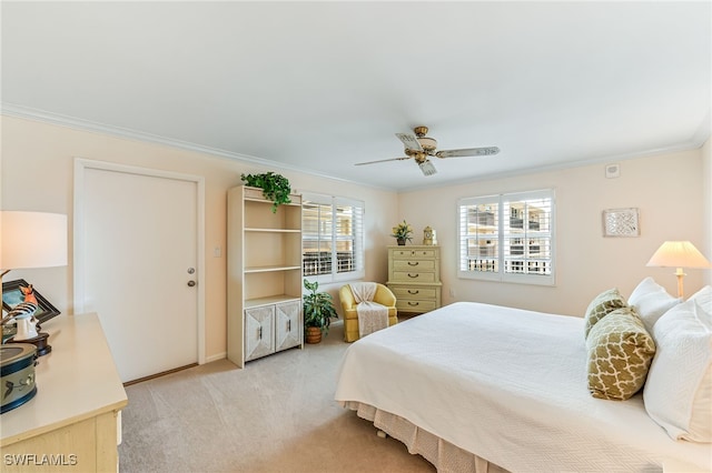 bedroom with ornamental molding, light colored carpet, baseboards, and ceiling fan