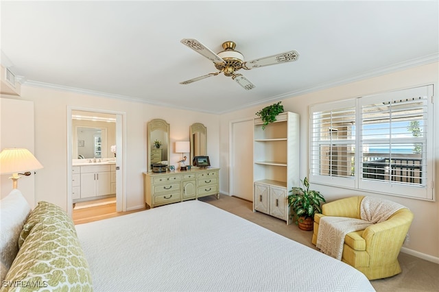 carpeted bedroom with crown molding, baseboards, connected bathroom, and a ceiling fan