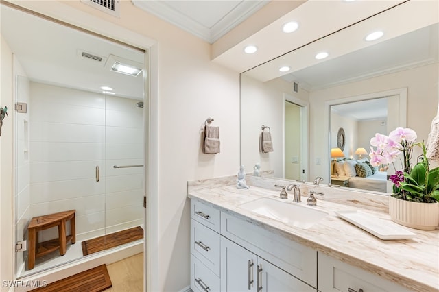bathroom featuring ornamental molding, a stall shower, recessed lighting, vanity, and ensuite bath