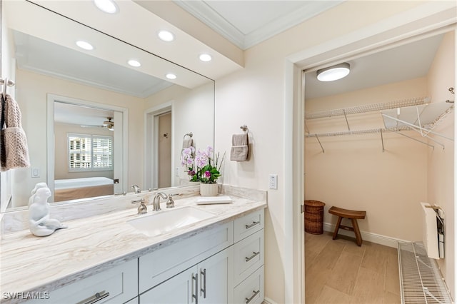 bathroom featuring ornamental molding, vanity, recessed lighting, ensuite bathroom, and a spacious closet