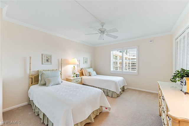 bedroom featuring crown molding, baseboards, light carpet, and ceiling fan