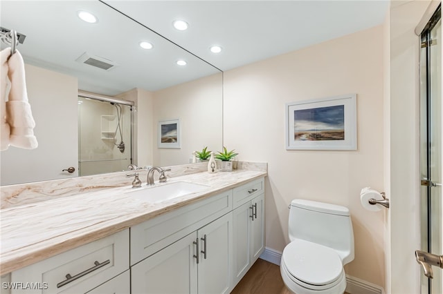 full bath featuring toilet, recessed lighting, a shower stall, vanity, and baseboards