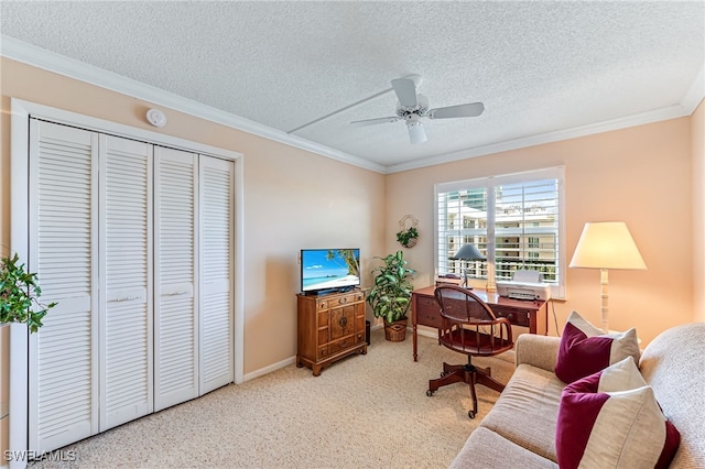 living room featuring a textured ceiling, ornamental molding, ceiling fan, baseboards, and carpet