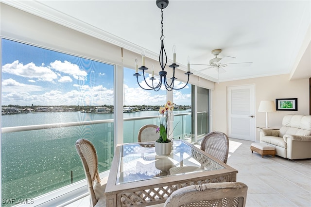 sunroom / solarium featuring a water view