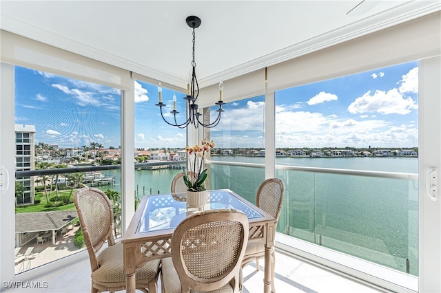 sunroom featuring a water view