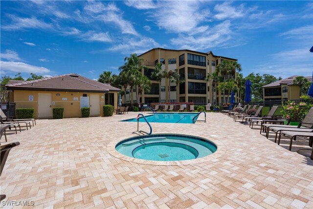 184 Vintage Cir Unit N202, Naples, FL 34119 - pool with fence, a patio area, and a hot tub