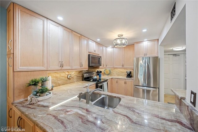 26000 Hickory Blvd Unit 604, Bonita Springs, FL 34134 - kitchen featuring decorative backsplash, light brown cabinetry, stainless steel appliances, and a sink