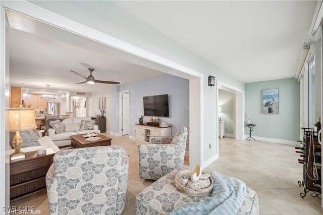 26000 Hickory Blvd Unit 604, Bonita Springs, FL 34134 - living room with baseboards, light tile patterned flooring, and ceiling fan with notable chandelier