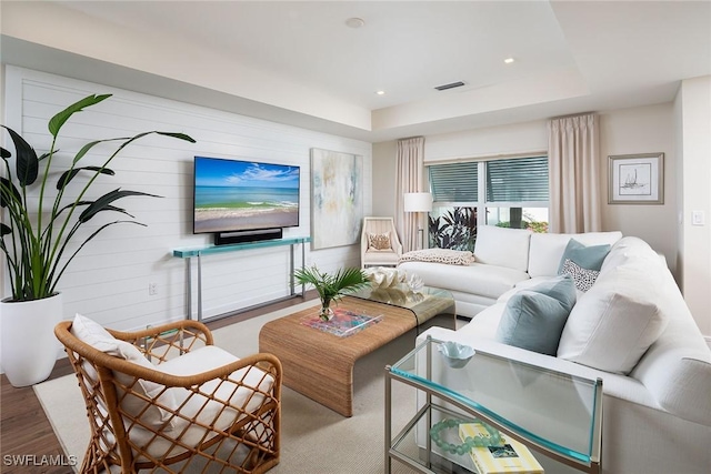 4830 W Blvd, Naples, FL 34103 - living room featuring a tray ceiling, recessed lighting, and wood finished floors