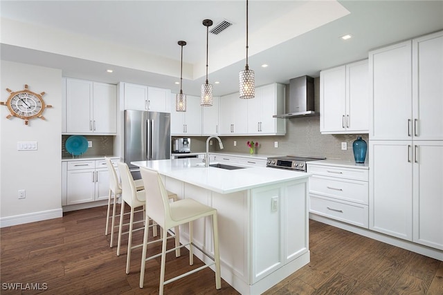 4830 W Blvd, Naples, FL 34103 - kitchen featuring wall chimney range hood, dark wood-style floors, backsplash, recessed lighting, and stainless steel appliances