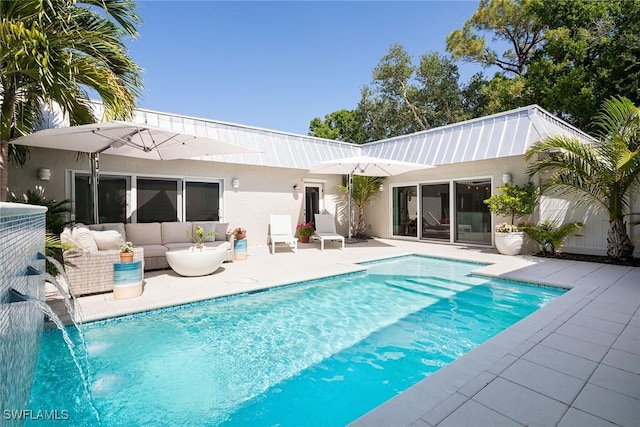 4830 W Blvd, Naples, FL 34103 - rear view of house with a patio area, an outdoor pool, stucco siding, and an outdoor living space
