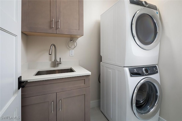 4830 W Blvd, Naples, FL 34103 - washroom featuring stacked washer and clothes dryer and cabinet space