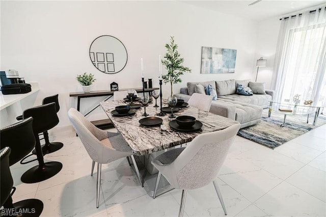 dining room with marble finish floor